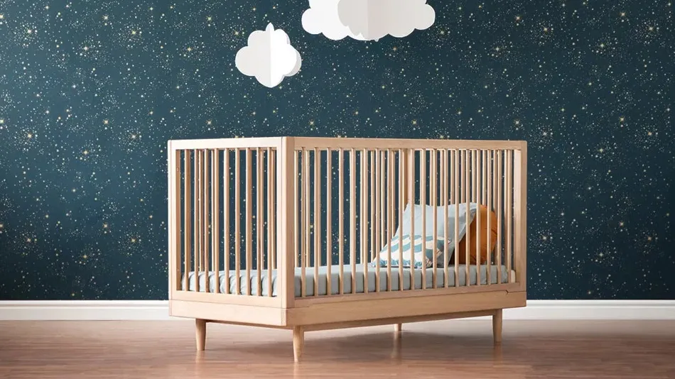 Best Cot Mattress in Australia A beautifully designed wooden baby cot set against a starry night-themed nursery wall.